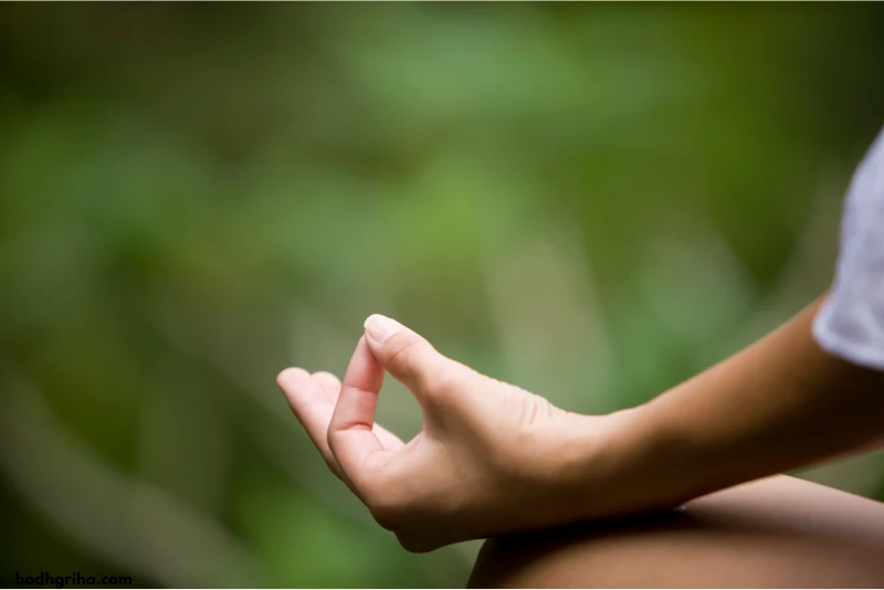 someone is sitting in a lotus position with their hands