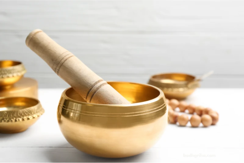 there is a golden bowl with a wooden stick in