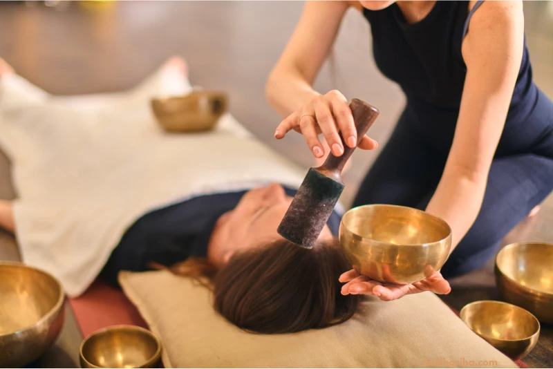 woman laying on a bed with a large bowl in